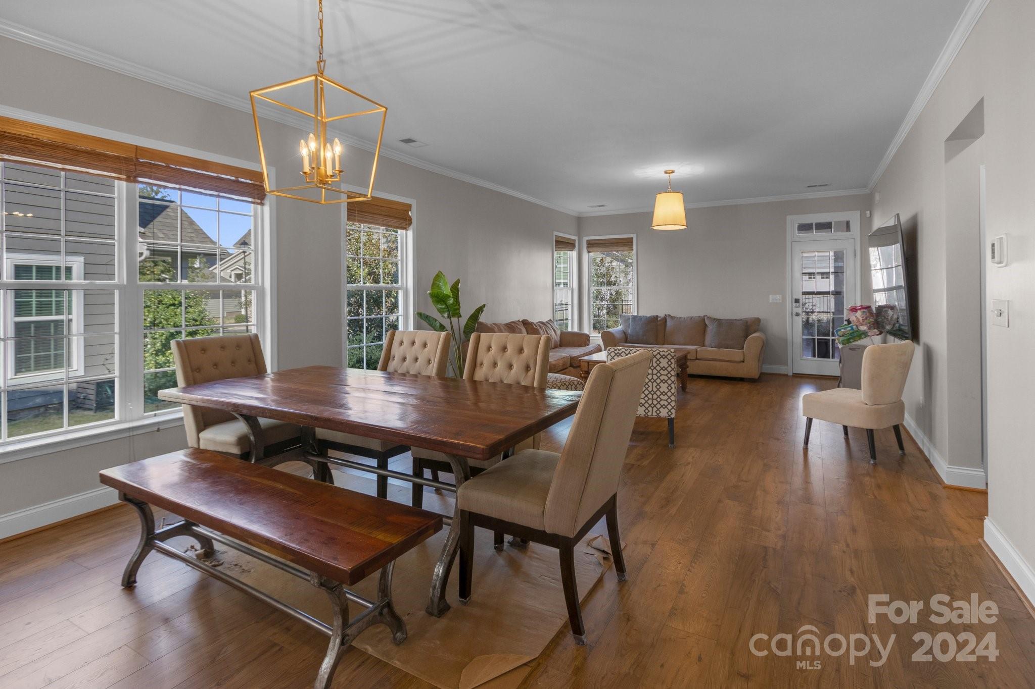 4095 Whittier Lane Fort Mill, SC 29708 - Photo 7 of 30 a view of a dining room with furniture wooden floor and chandelier