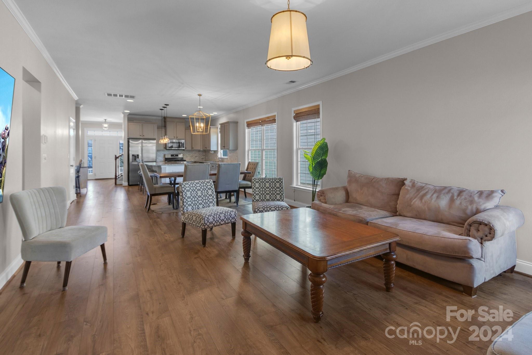 4095 Whittier Lane Fort Mill, SC 29708 - Photo 9 of 30 a living room with furniture wooden floor and a chandelier