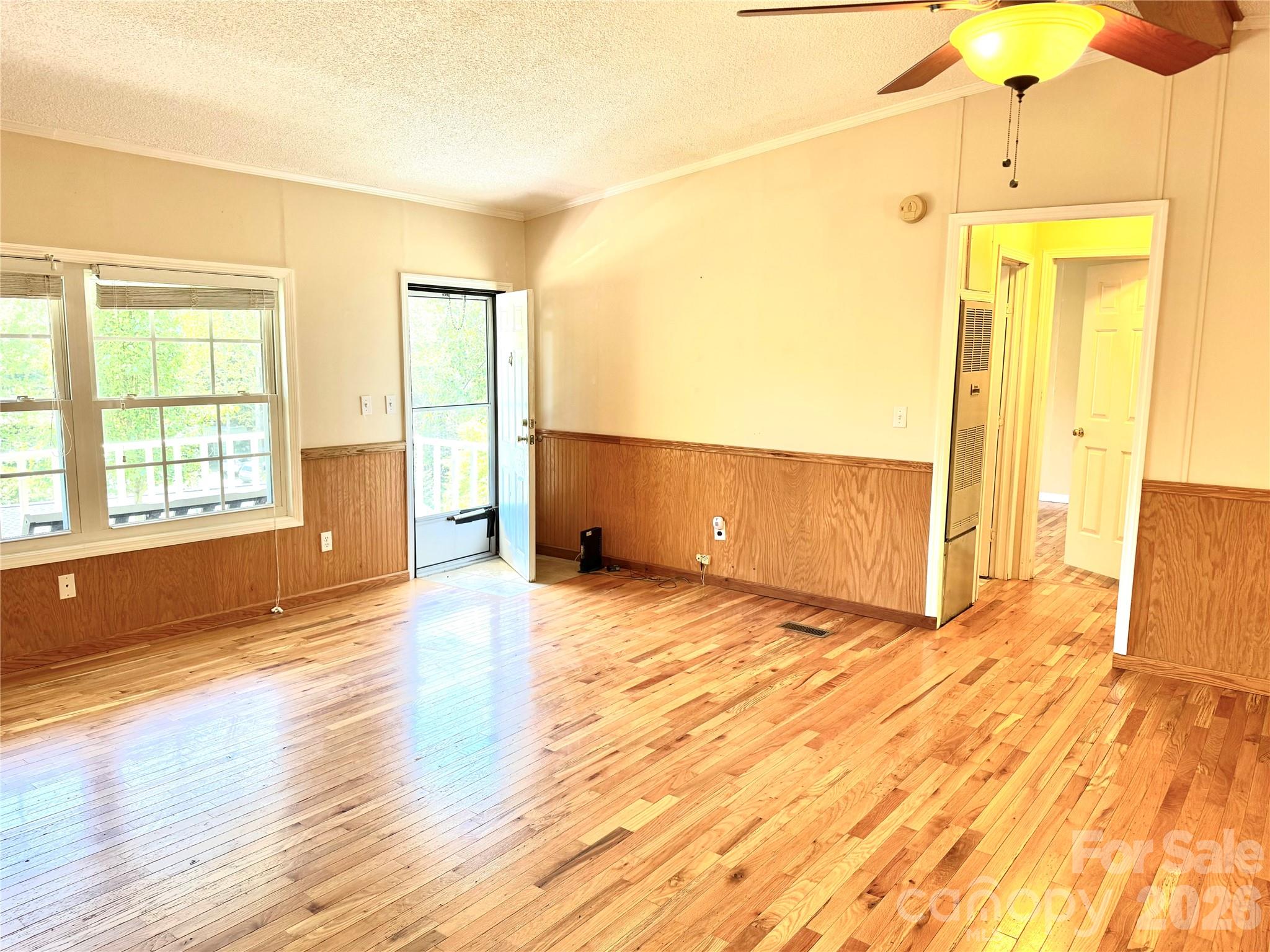 942 Fisher Branch Road Marshall, NC 28753 - Photo 12 of 38 a view of an empty room with wooden floor and a window