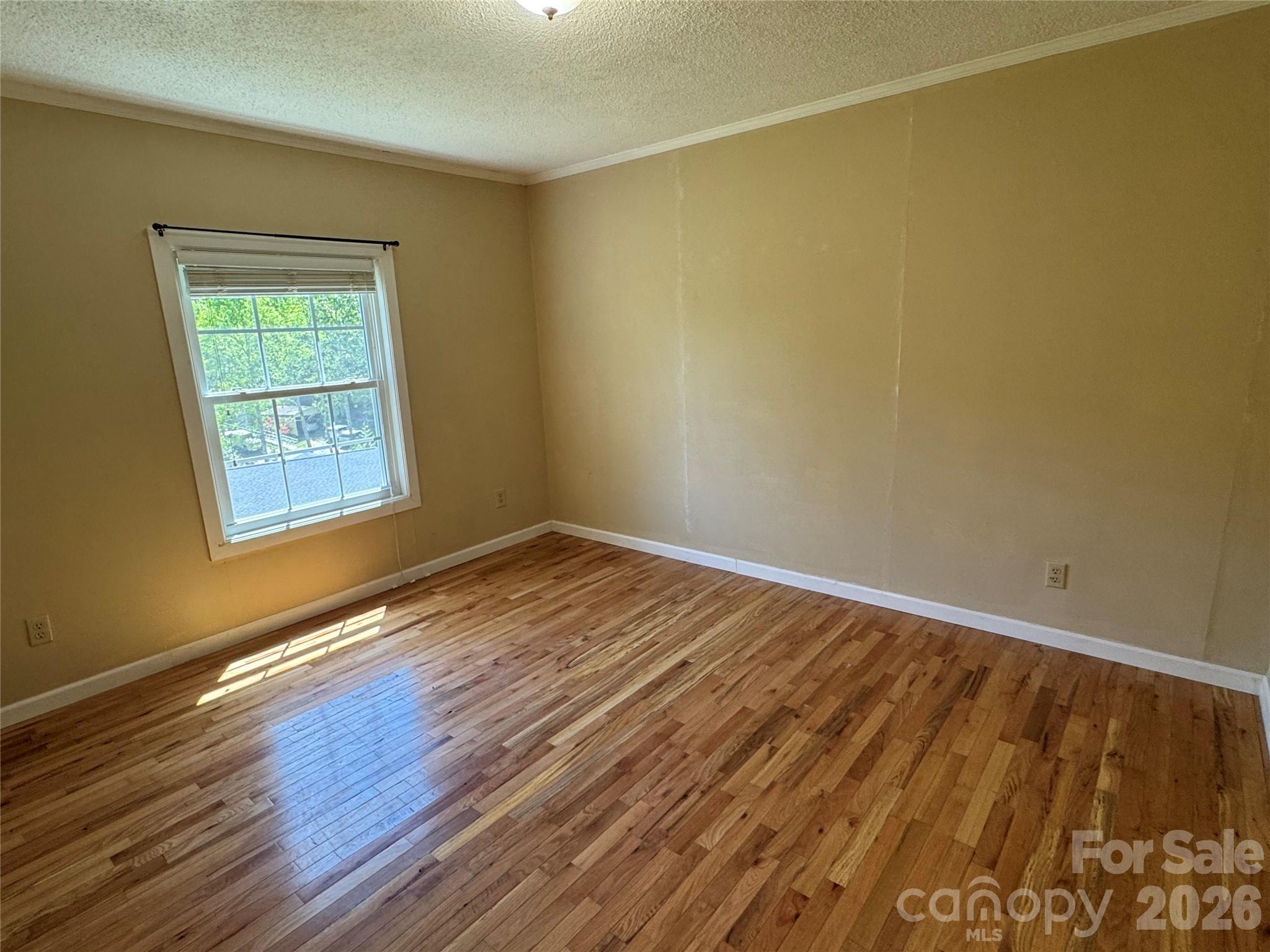 942 Fisher Branch Road Marshall, NC 28753 - Photo 15 of 38 a view of an empty room with wooden floor and a window