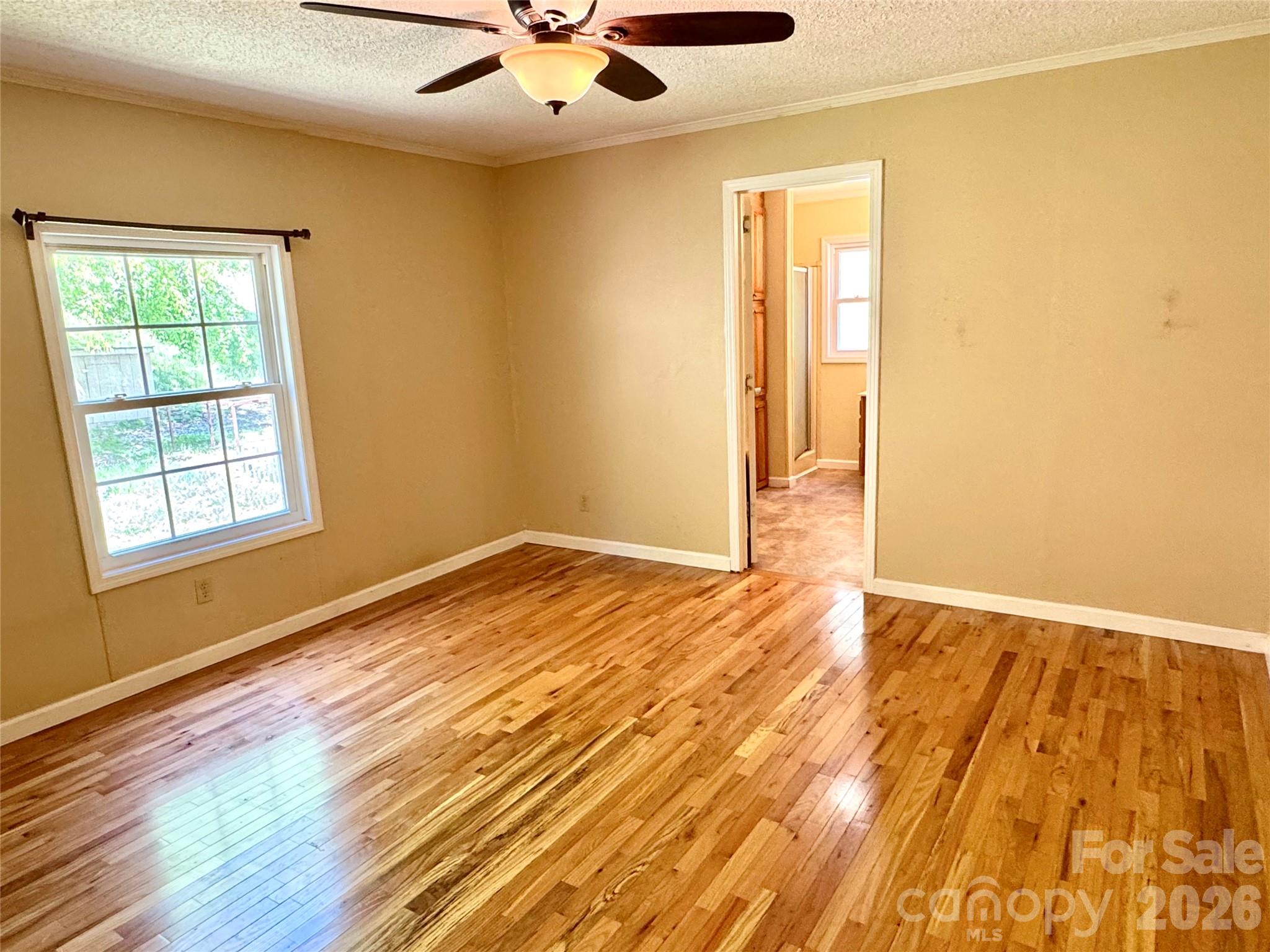 942 Fisher Branch Road Marshall, NC 28753 - Photo 17 of 38 a view of an empty room with wooden floor and a window