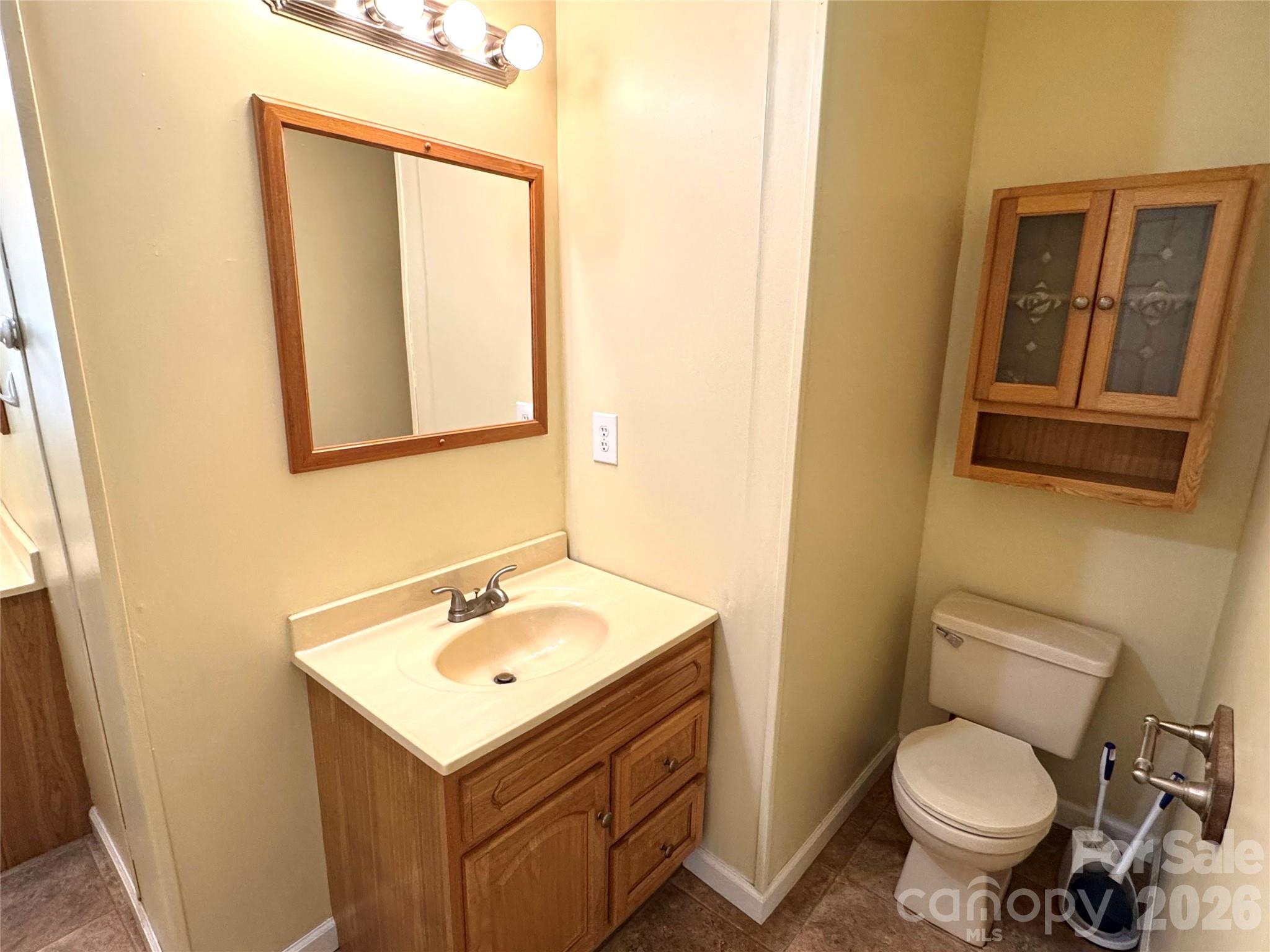942 Fisher Branch Road Marshall, NC 28753 - Photo 19 of 38 a bathroom with a toilet sink and mirror