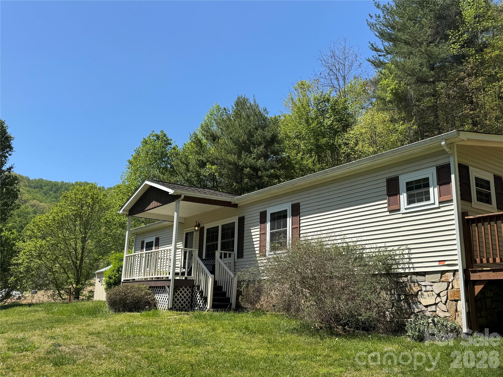 942 Fisher Branch Road Marshall, NC 28753 - Photo 2 of 38 a front view of a house with a garden