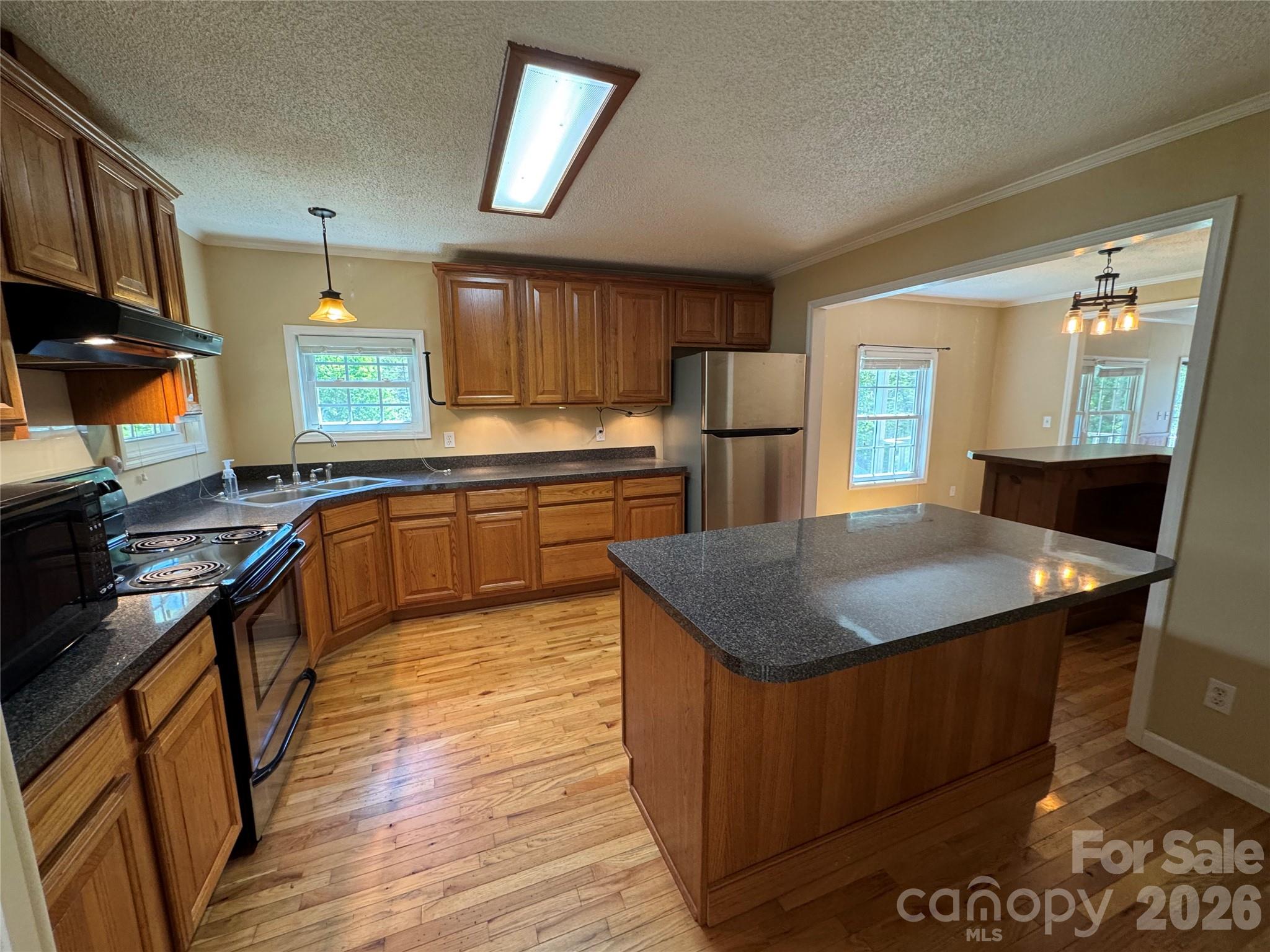 942 Fisher Branch Road Marshall, NC 28753 - Photo 5 of 38 a kitchen with stainless steel appliances granite countertop a sink stove and refrigerator