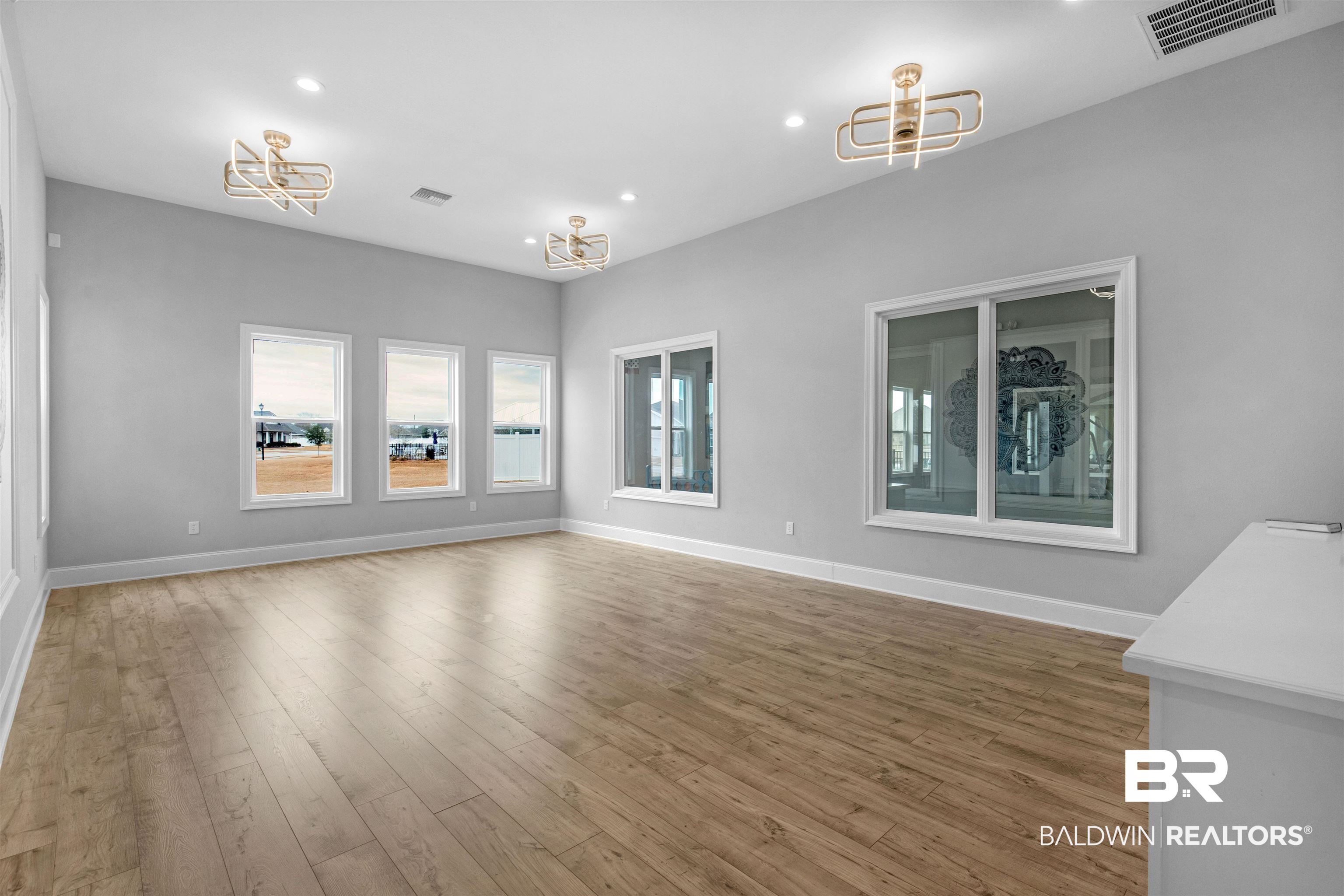10313 Ruffian Route Daphne, AL 36526 - Photo 41 of 46 Unfurnished living room featuring hardwood / wood-style flooring and a notable chandelier