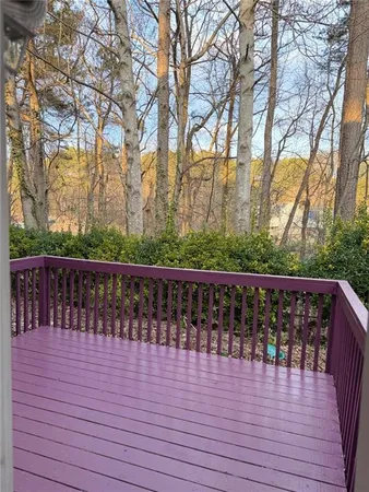a balcony with wooden floor and fence