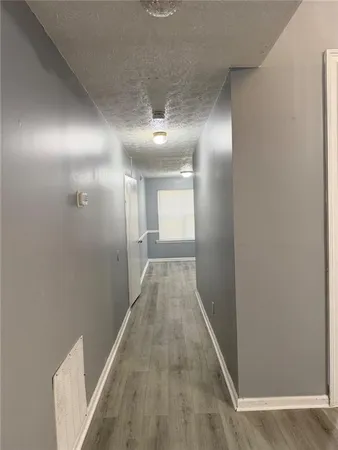 a view of a hallway with wooden floor