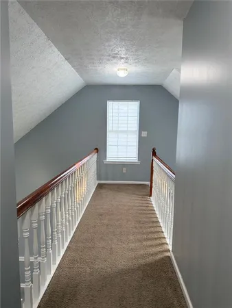 a view of a hallway with windows