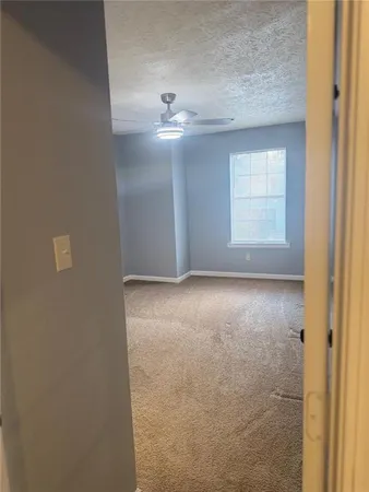 an empty room with a empty space and windows