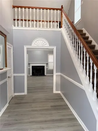 a view of entryway and hall with wooden floor