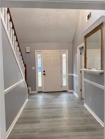 a view of a hallway view with wooden floor and staircase