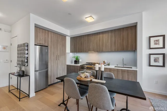 a kitchen with stainless steel appliances granite countertop a refrigerator and a stove top oven