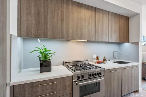 a kitchen with a stove and a white cabinets