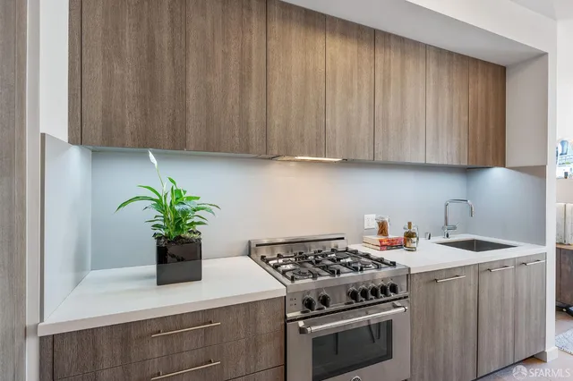a kitchen with a stove and a white cabinets