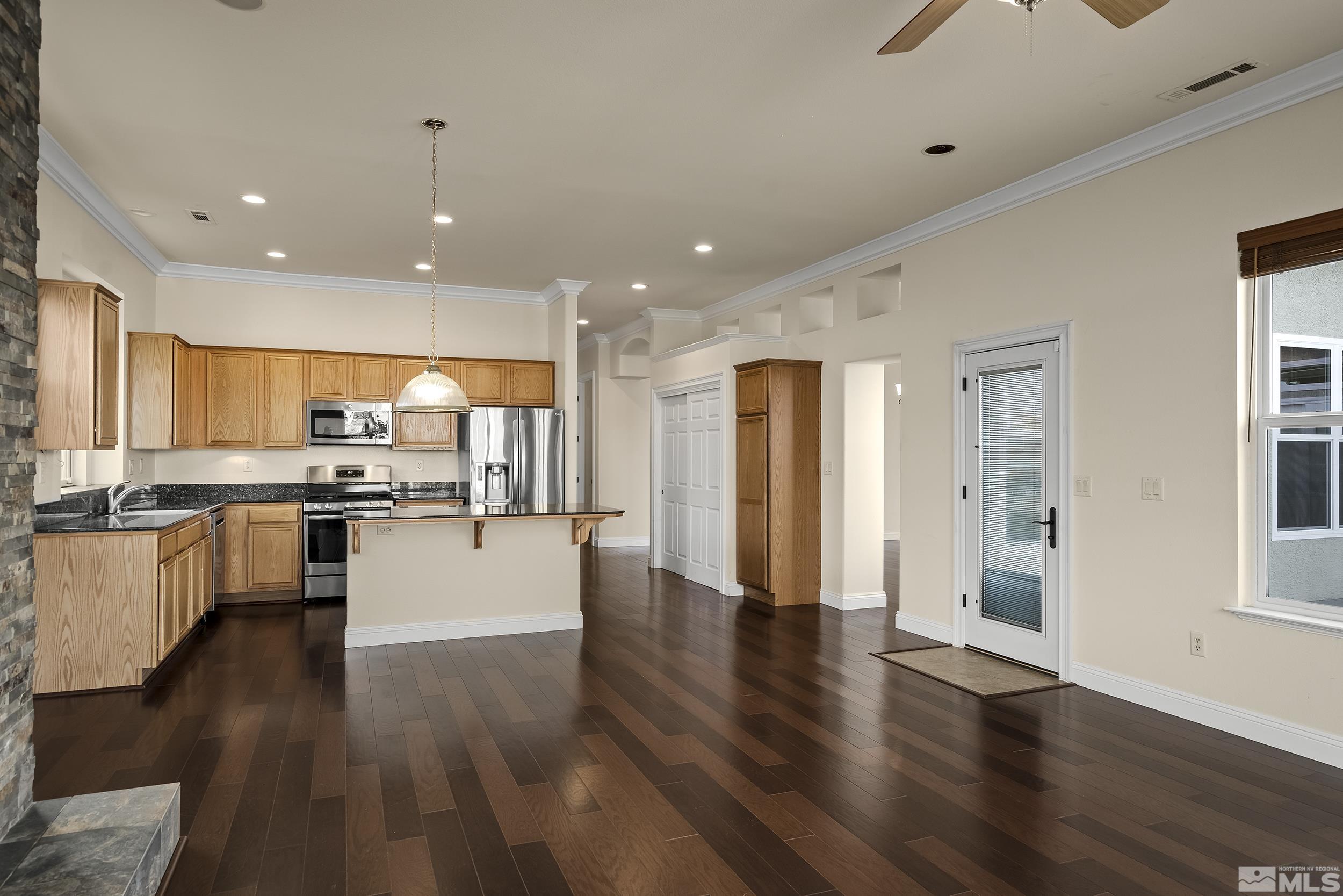 1575 Wyatt Court Reno, NV 89521 - Photo 11 of 40 a view of kitchen with cabinets and wooden floor