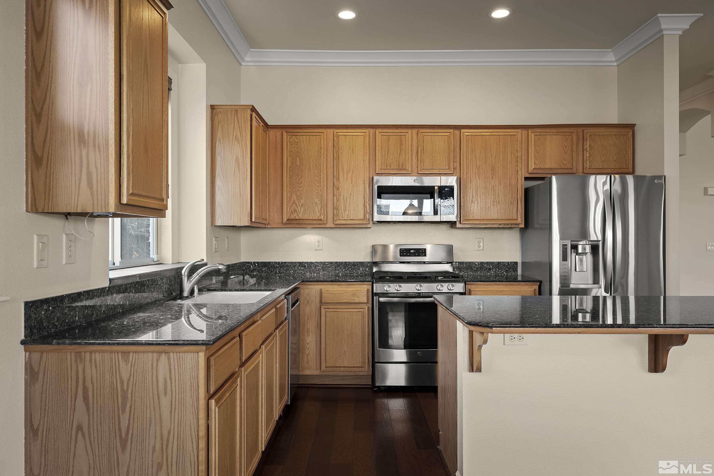 1575 Wyatt Court Reno, NV 89521 - Photo 13 of 40 a kitchen with a sink stove and refrigerator