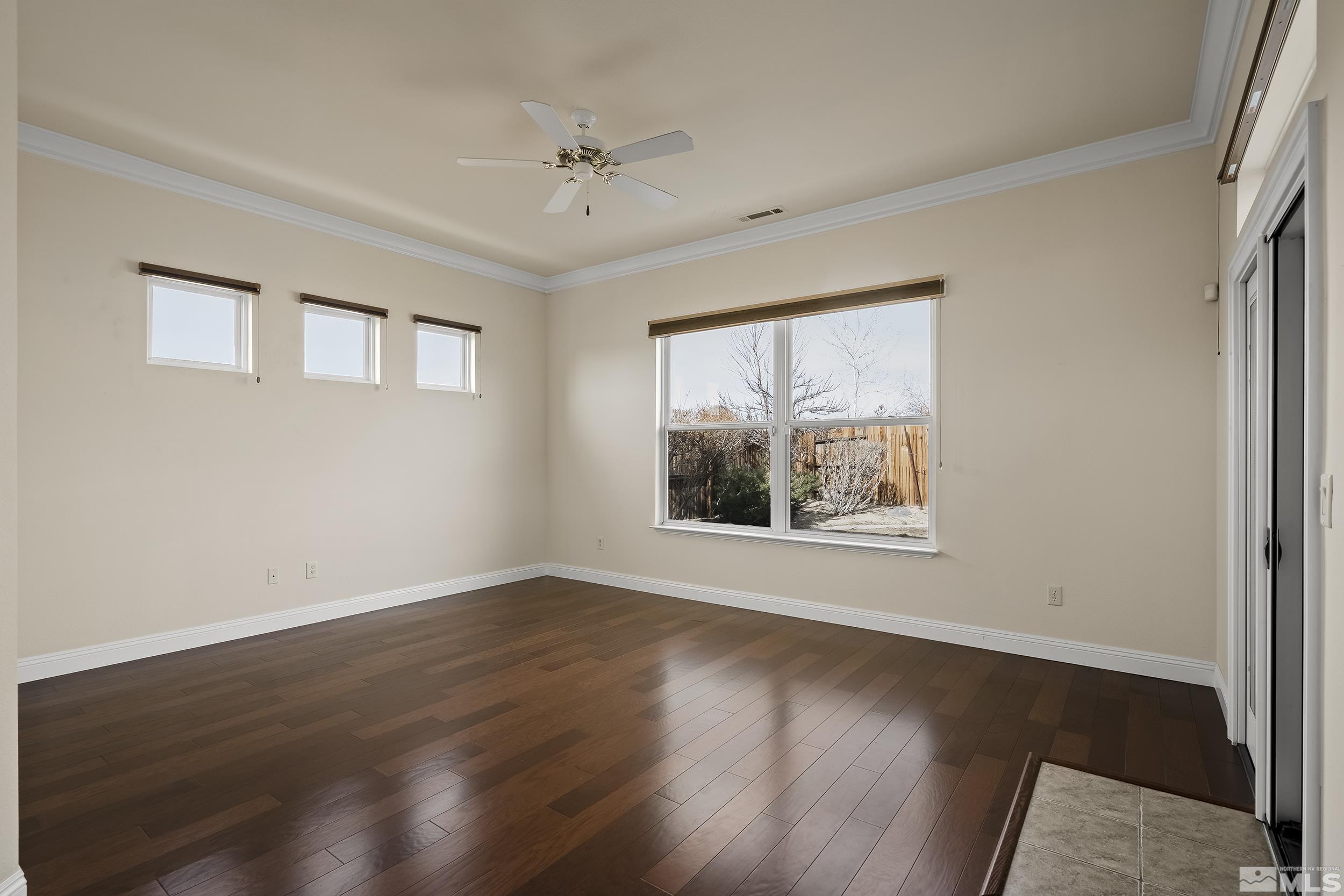 1575 Wyatt Court Reno, NV 89521 - Photo 15 of 40 a view of an empty room with wooden floor and a window