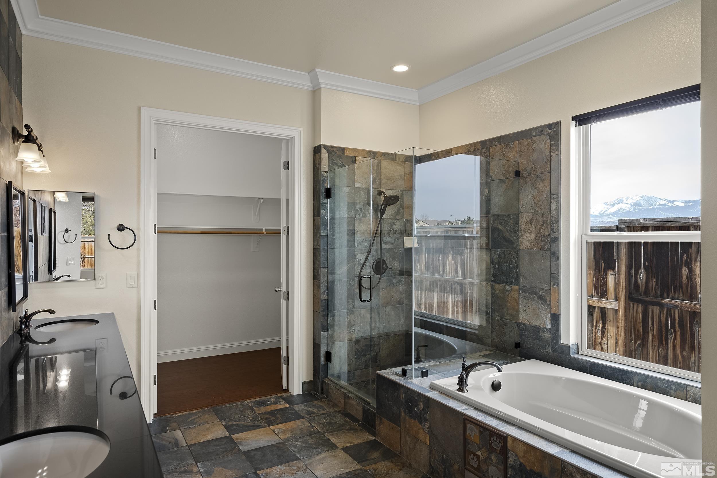 1575 Wyatt Court Reno, NV 89521 - Photo 17 of 40 a bathroom with a tub sink and mirror
