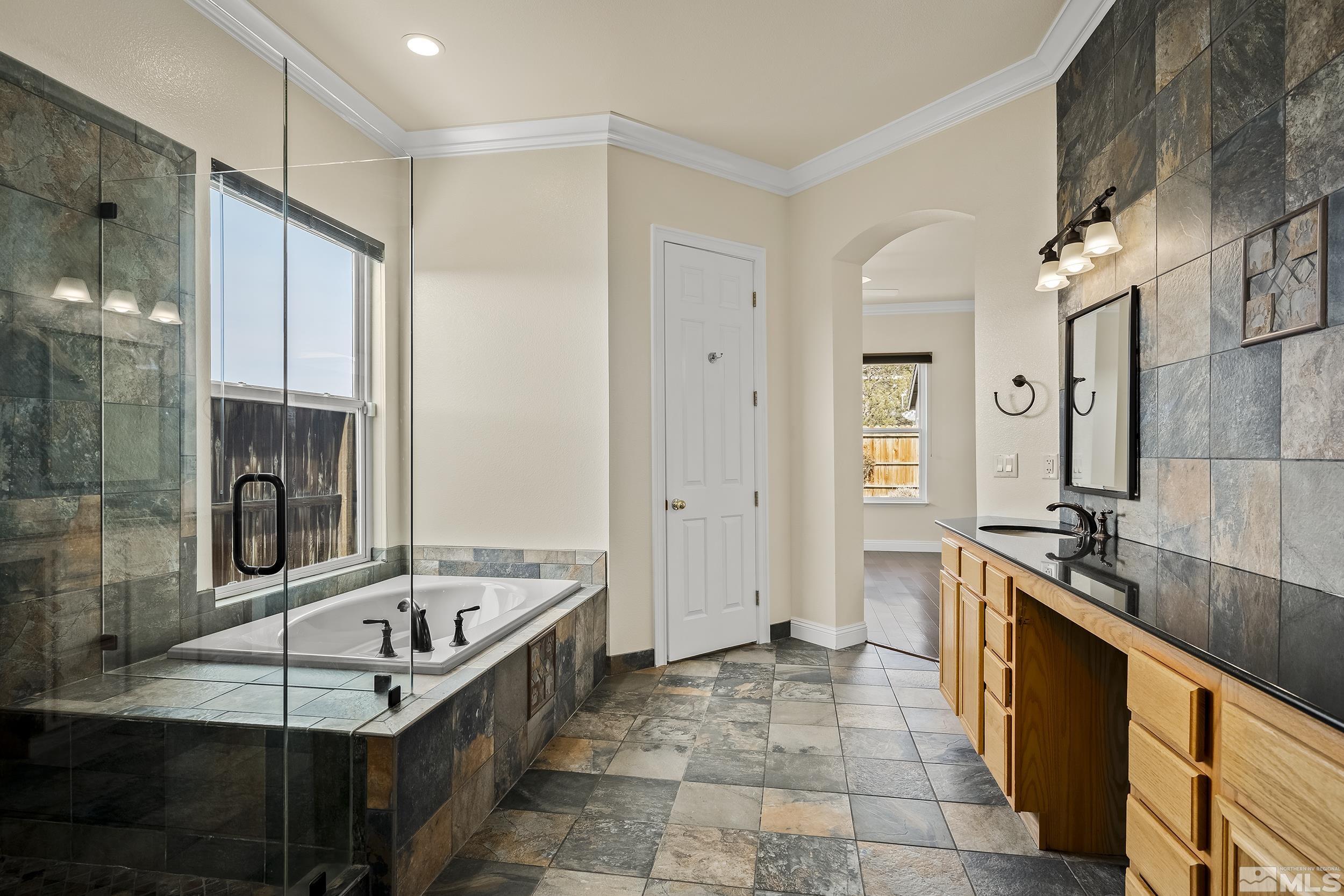 1575 Wyatt Court Reno, NV 89521 - Photo 18 of 40 a large white kitchen with granite countertop a sink and a refrigerator