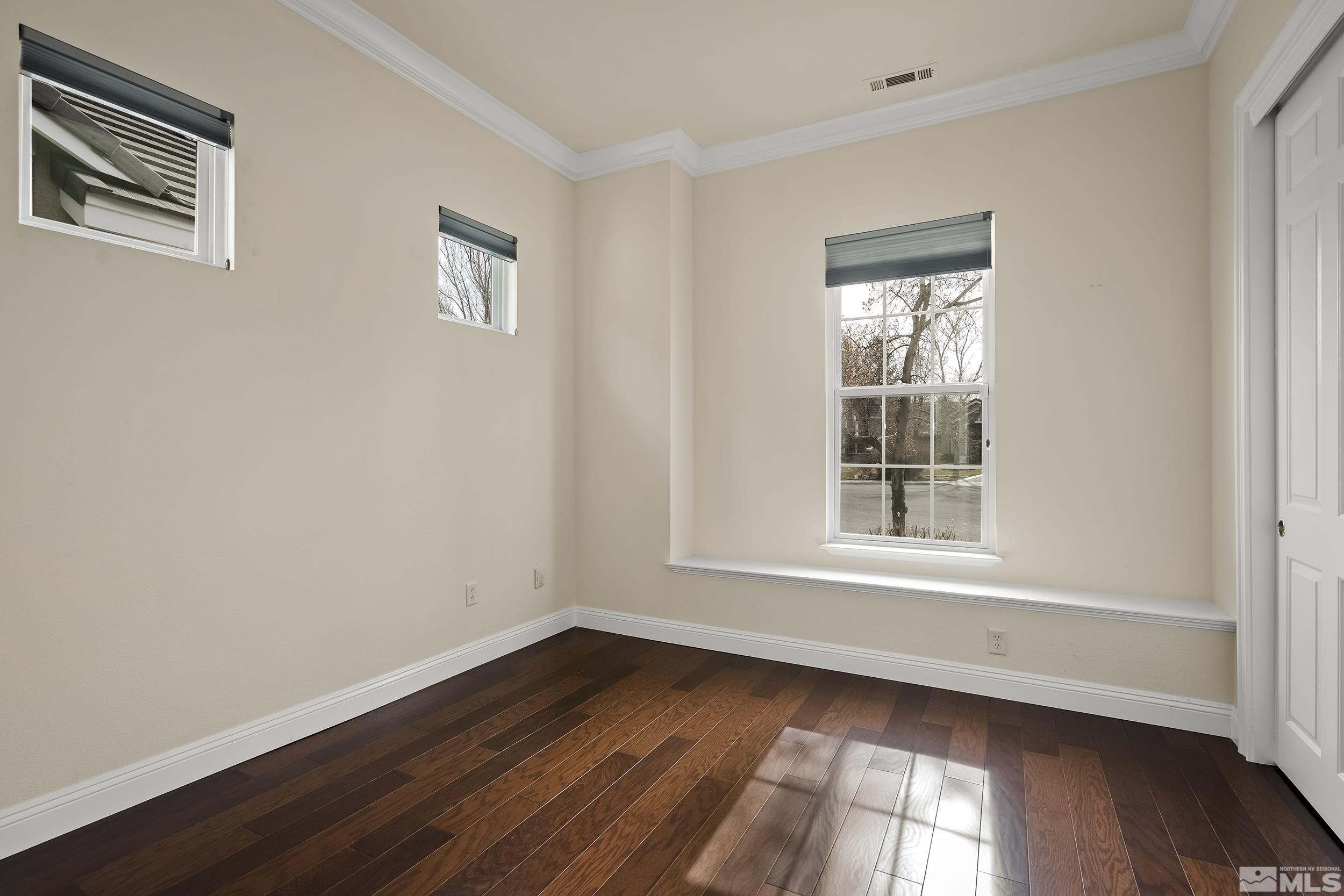 1575 Wyatt Court Reno, NV 89521 - Photo 20 of 40 a view of an empty room with wooden floor and a window