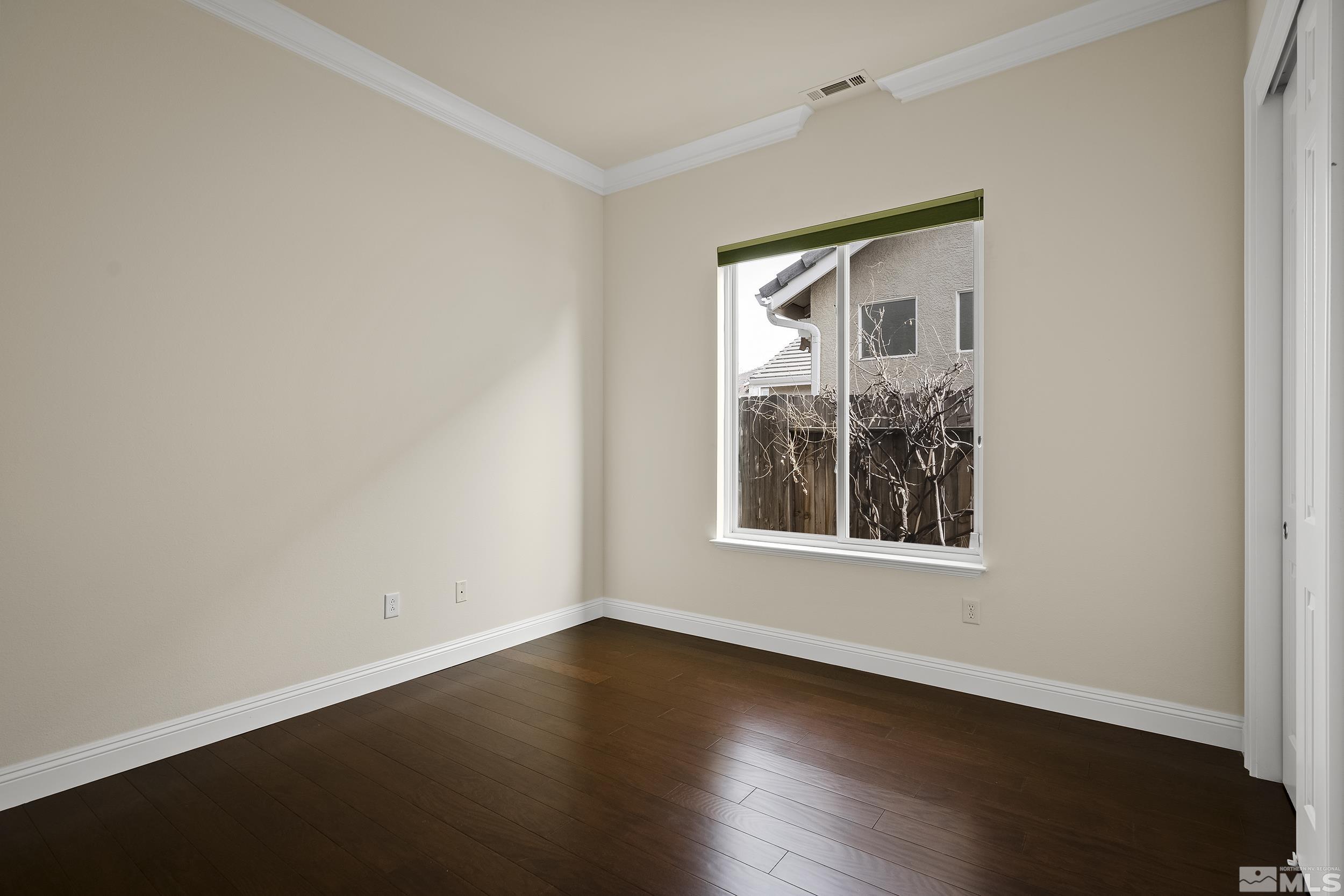 1575 Wyatt Court Reno, NV 89521 - Photo 22 of 40 an empty room with wooden floor and windows