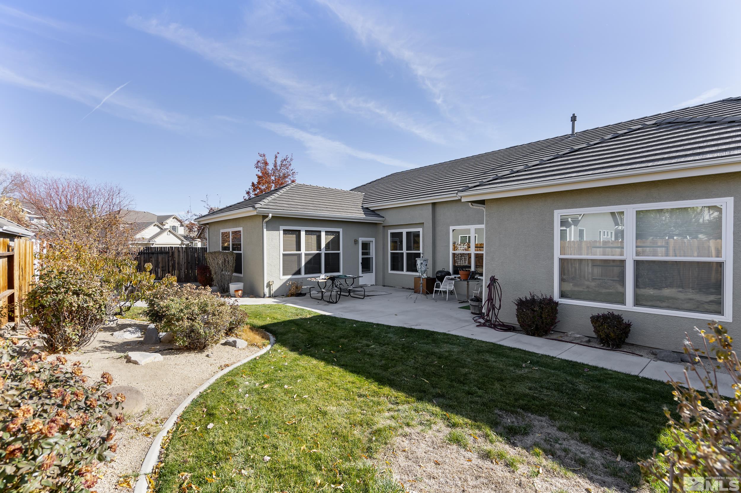 1575 Wyatt Court Reno, NV 89521 - Photo 26 of 40 a front view of a house with a garden and patio