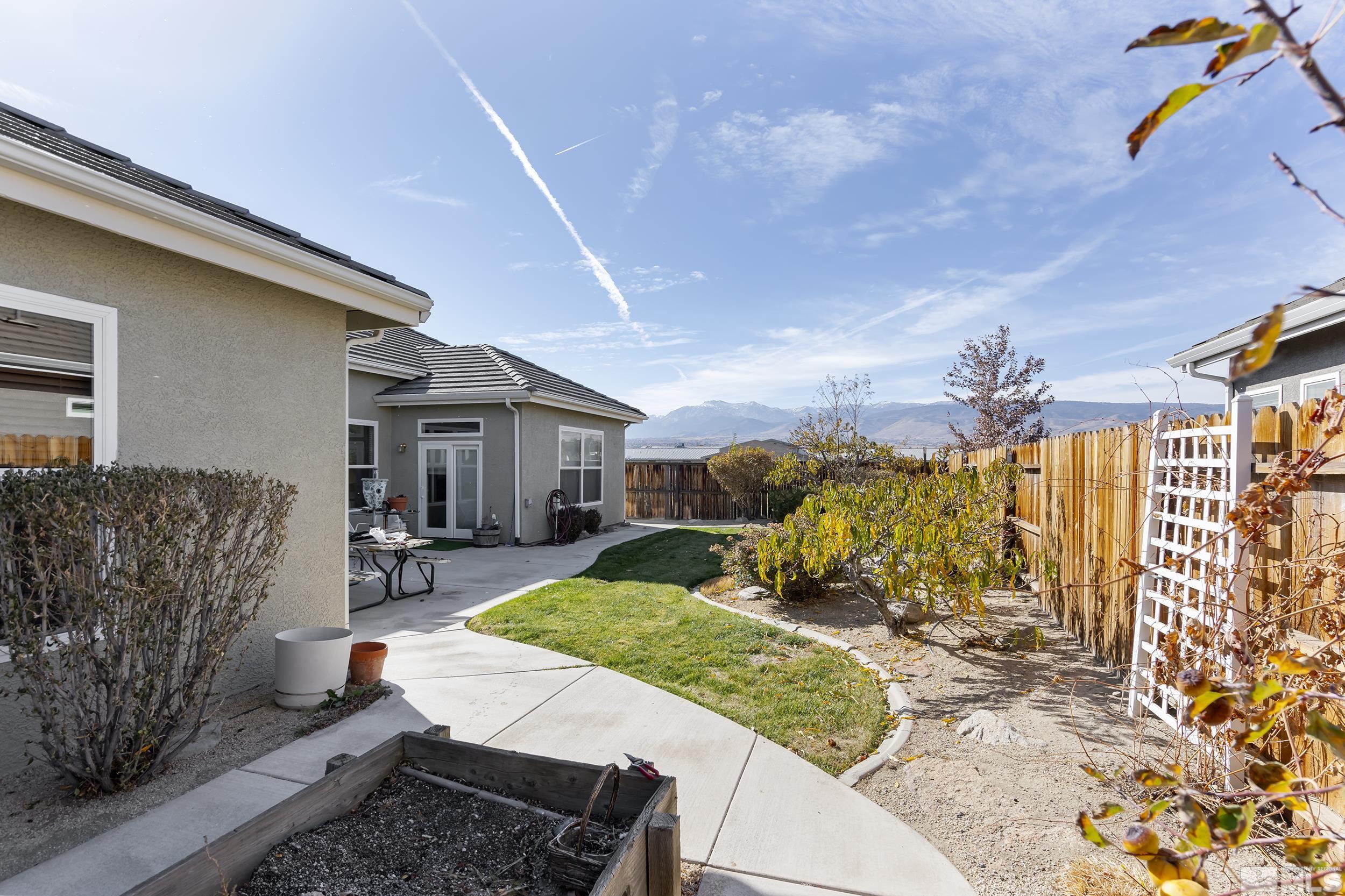 1575 Wyatt Court Reno, NV 89521 - Photo 27 of 40 a view of a patio with couches table and chairs and potted plants