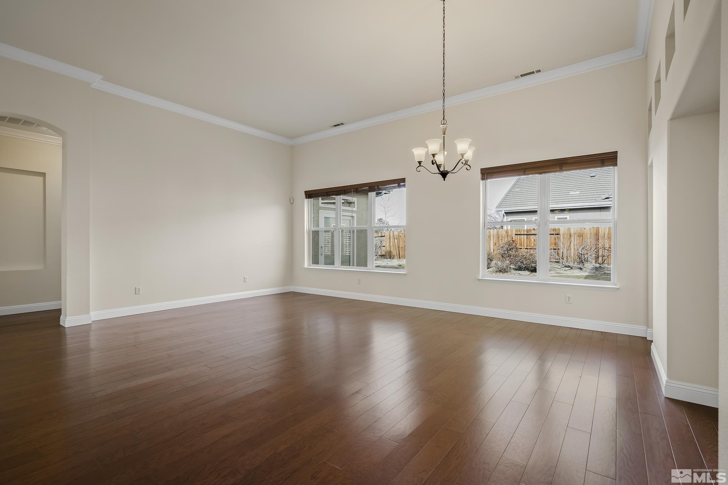 1575 Wyatt Court Reno, NV 89521 - Photo 3 of 40 a view of an empty room with wooden floor and a window