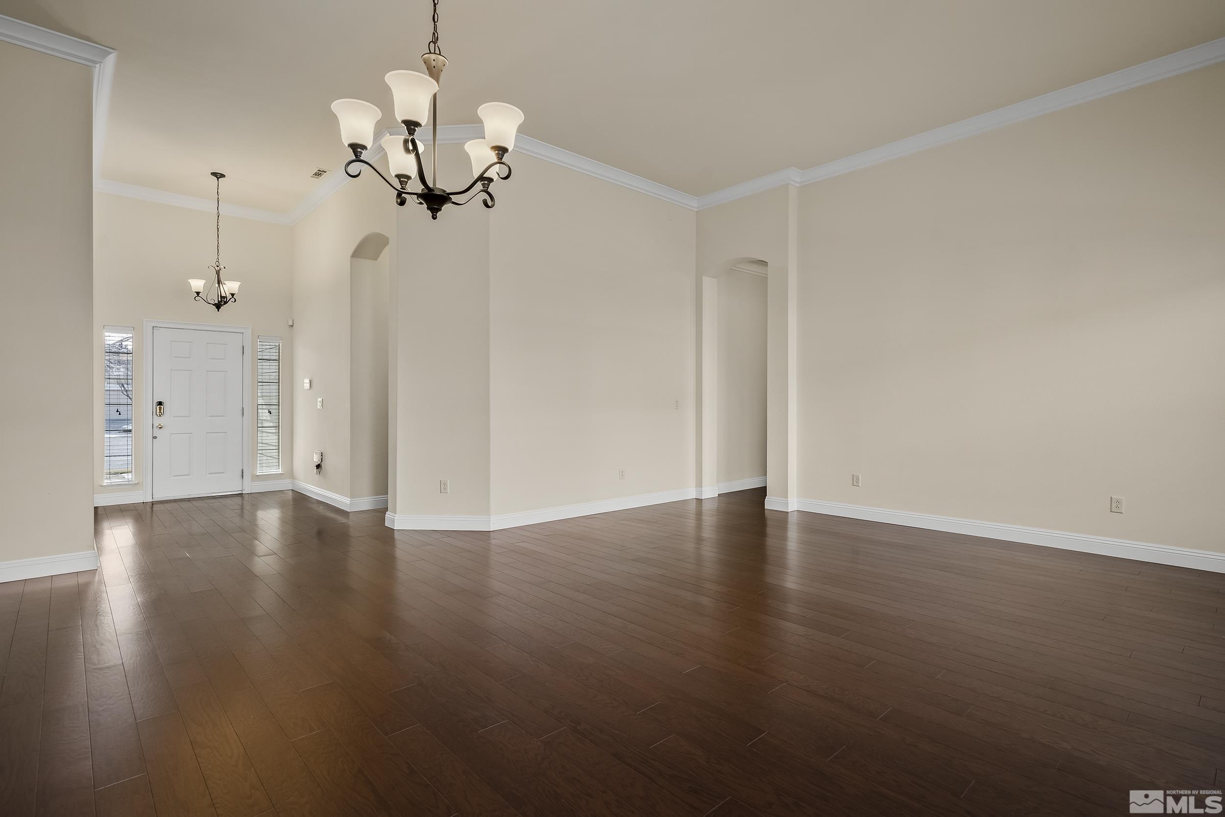 1575 Wyatt Court Reno, NV 89521 - Photo 6 of 40 a view of an empty room with wooden floor and a window