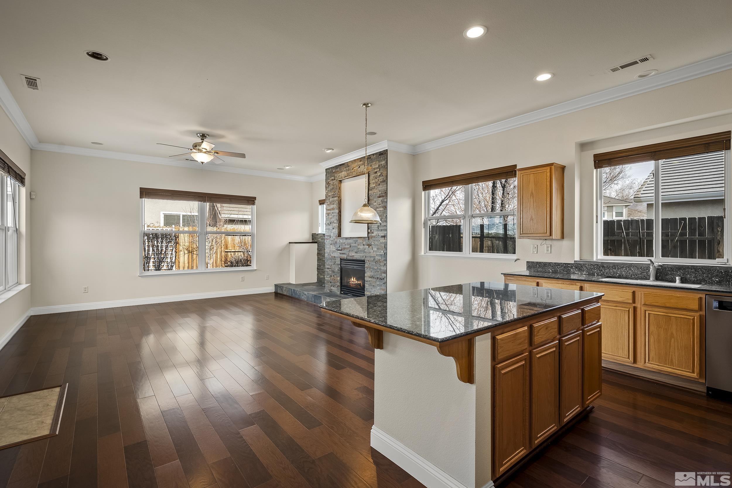 1575 Wyatt Court Reno, NV 89521 - Photo 7 of 40 a kitchen that has a lot of cabinets in it with wooden floor and a window