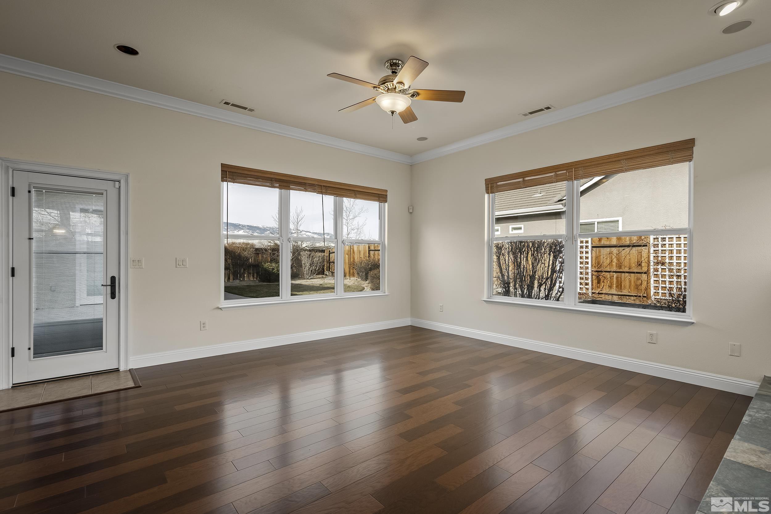 1575 Wyatt Court Reno, NV 89521 - Photo 9 of 40 a view of an empty room with wooden floor and a window