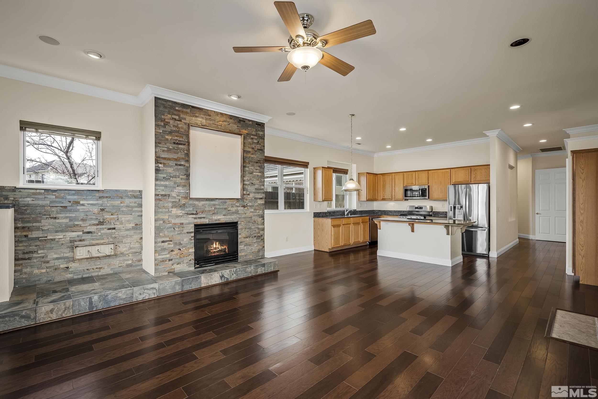 1575 Wyatt Court Reno, NV 89521 - Photo 10 of 40 an open kitchen view with fireplace and wooden floor