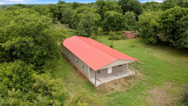 a house with green field in front of it