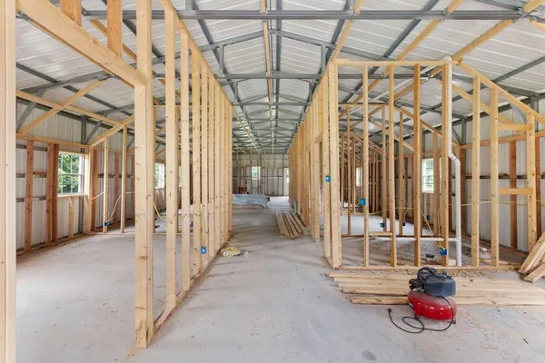 a view of a hallway with a glass door and chandelier