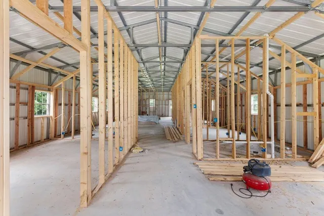a view of a hallway with a glass door and chandelier