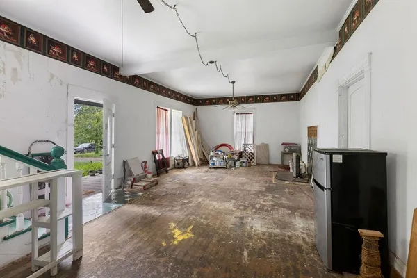 a bathroom with a toilet and shower curtain