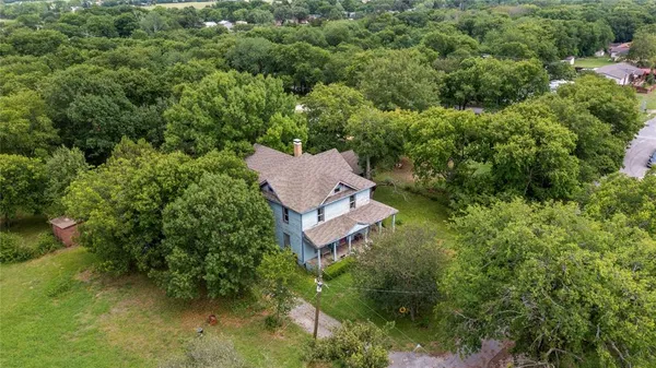 an aerial view of a house with a yard