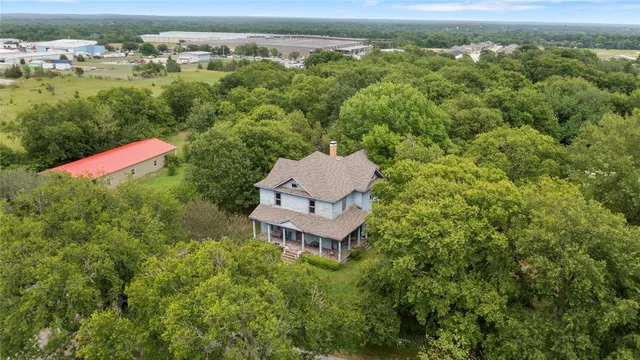 an aerial view of a house with a yard
