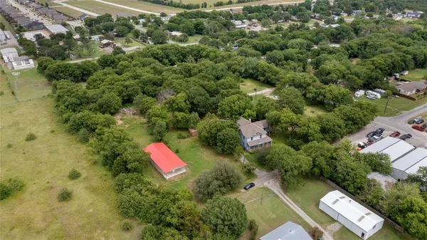 an aerial view of a house with a yard and lake