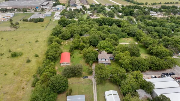 an aerial view of residential houses with yard