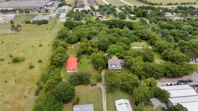 an aerial view of residential houses with yard