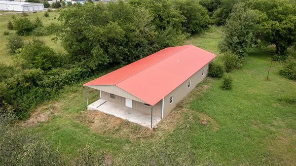 a view of a backyard with a small house and a yard