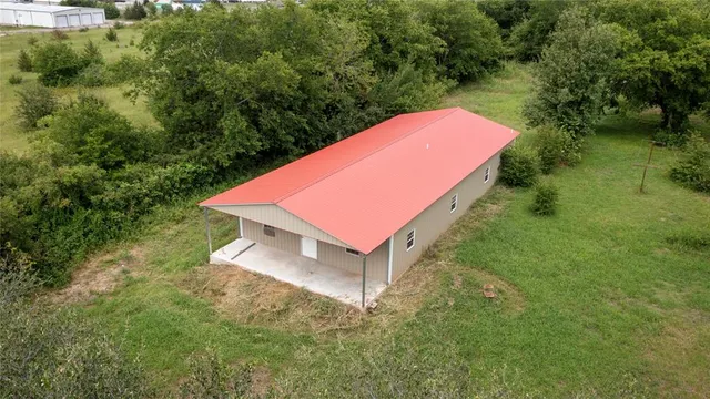 a view of a backyard with a small house and a yard