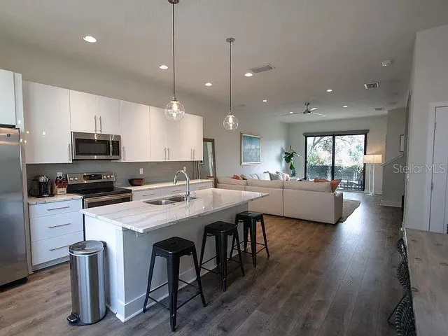 a kitchen with counter space appliances and a chair