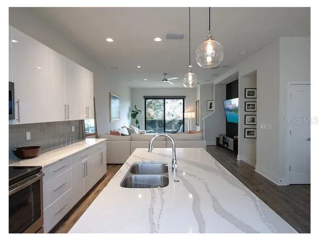 a kitchen with counter top space appliances and a window