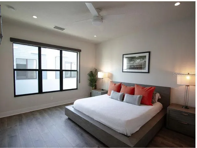 a bedroom with a large bed and a window