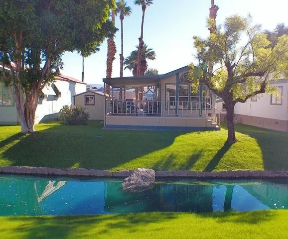 a view of a house with swimming pool and a yard