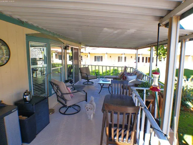 a view of an chairs and table in the balcony