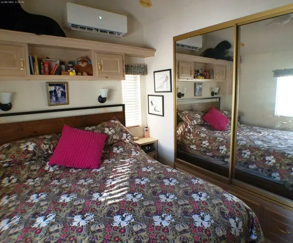 a bed in a bedroom next to a window