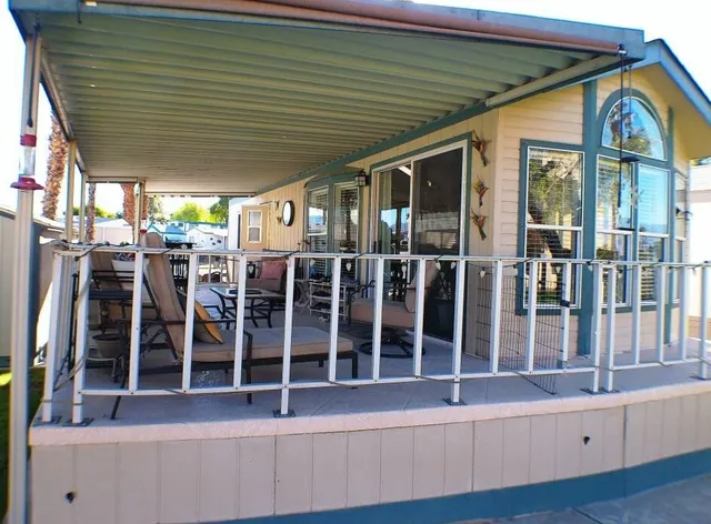 a front view of a house with glass windows and stairs